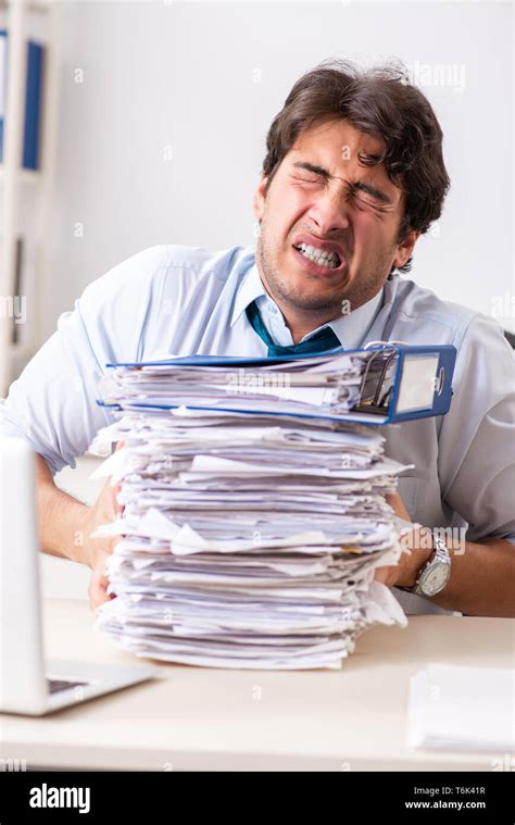 Overloaded Busy Employee With Too Much Work And Paperwork Stock Photo