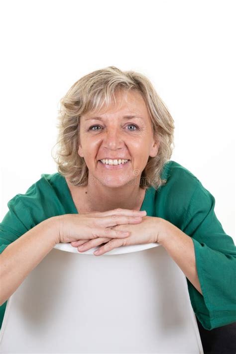 Smiling Cute Mature Woman Senior Blond Sitting On White Background