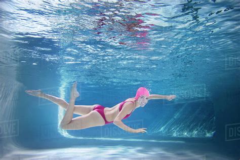 Caucasian Woman In Bikini Swimming Underwater Stock Photo Dissolve