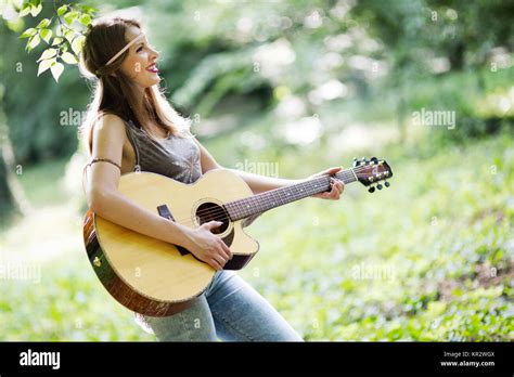 Beautiful Woman Playing Guitar In Nature Stock Photo Alamy