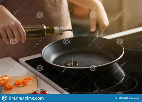 Woman Pouring Olive Oil Onto Frying Pan On Stove Stock Image Image Of