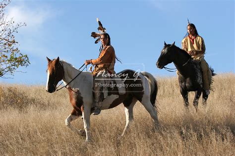 Two Native American Indian Men On Horseback Scouting For Enemies Or