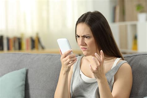 Angry Woman Looking At Smart Phone At Home Vici Media