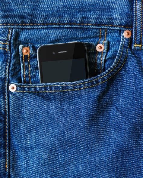 Modern Smart Phone In Front Pocket Of Blue Denim Jeans Stock Photo