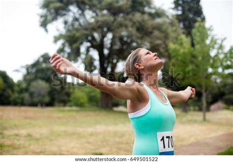 Female Athlete Arms Outstretched Park On Stock Photo 649501522