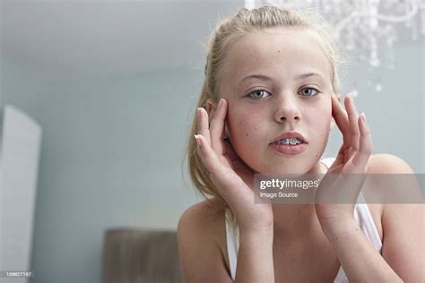 Teenage Girl Touching Her Face Photo Getty Images