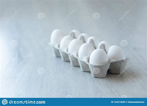 White Chicken Eggs In An Open Cardboard Box On A Light Background A