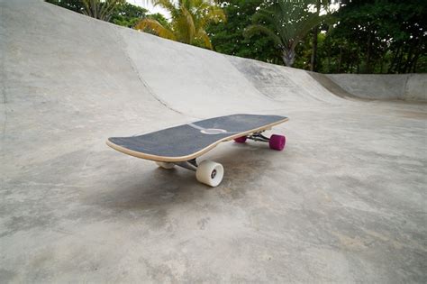 Premium Photo Skateboard Longboard In Skate Park With Concrete Bowl