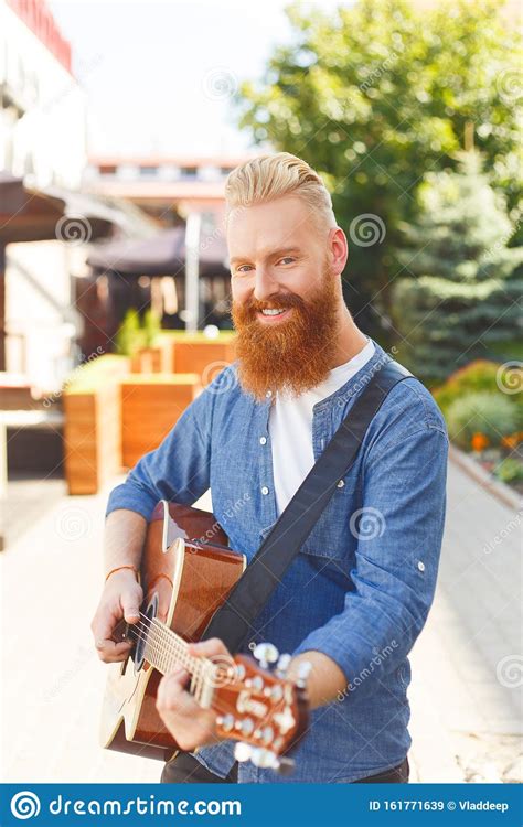 If you want to learn to play the blues guitar then you must learn to take inspiration from people like him. Young Bearded Man Wearing Blue Denim Jacket, Playing ...