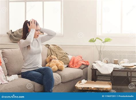 Desperate Woman Sitting On Sofa In Messy Room Stock Image Image Of