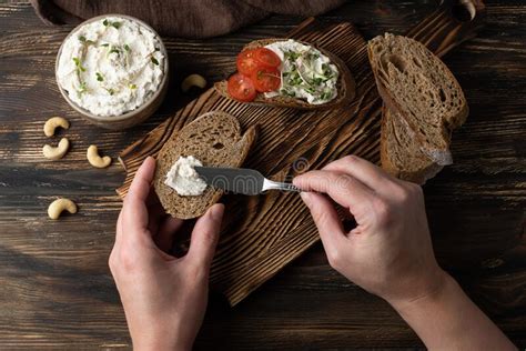 Female Hands Spreading Vegan Cashew Cream Cheese On A Slice Of Bread Stock Image Image Of
