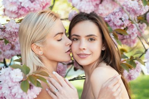 Premium Photo Portrait Of A Two Beautiful Spring Girls Two Young Women Relaxing In Sakura