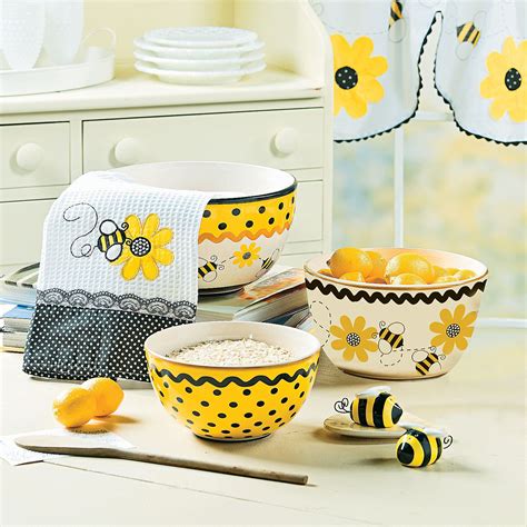 Yellow And Black Bowls With Bees On Them Are Sitting On A Counter Next