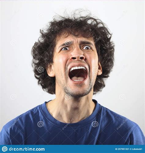 Angry Man Screaming At Somebody Worried And Shocked Young Man Stock