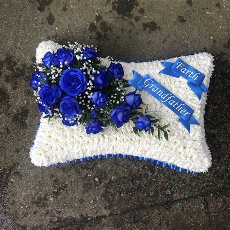 Delivering wholesale glass vases australia wide. Blue and white pillow funeral flowers tribute wreath with ...