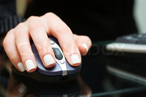 Top view of woman using computer hand. Female hand holding computer mouse | Stock image | Colourbox