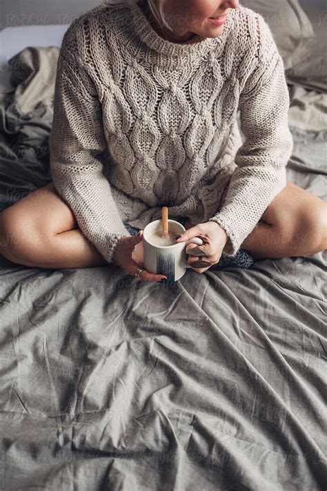 woman drinking hot coffee in bed in the morning by stocksy contributor lumina stocksy