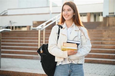 Premium Photo Female College Student With Books Outdoors Smiling