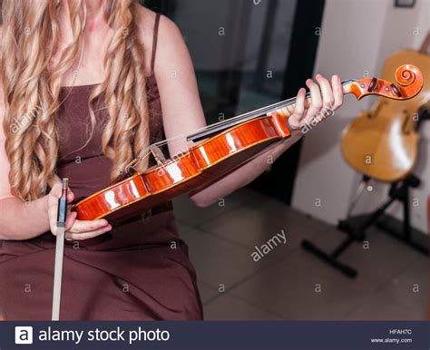 A Woman Holding A Violin Stock Photo Alamy