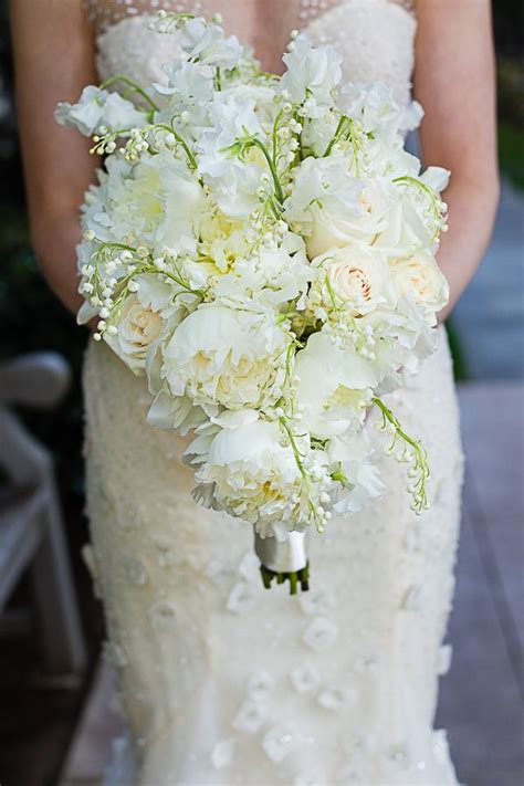 Romantic, elegant, rose & peony filled wedding. white peony, rose, lily of the valley and sweet pea ...
