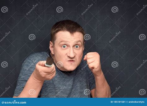 Portrait Of Angry Man Holding Knife And Shaking Fist Stock Image