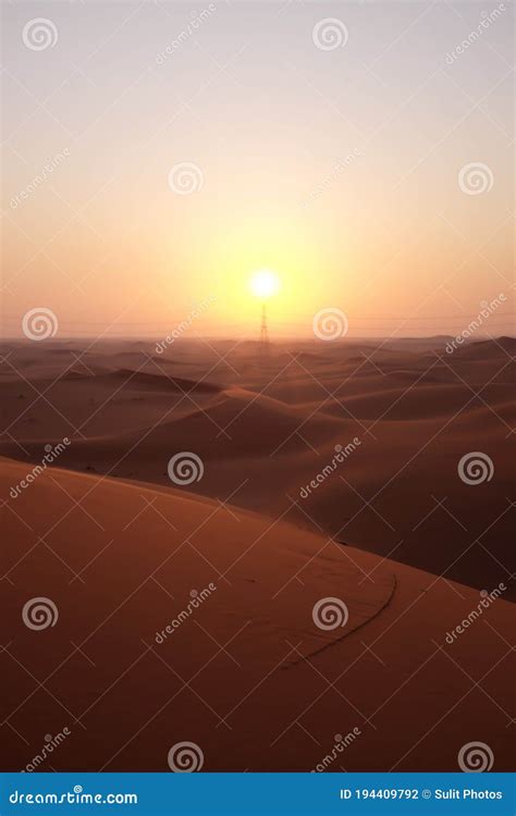 Portrait Of Beautiful Desert Sunrise With Power Transmission Tower In