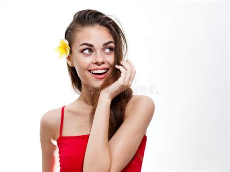 woman with a flower in her hair looking to the side on a light background stock image image of