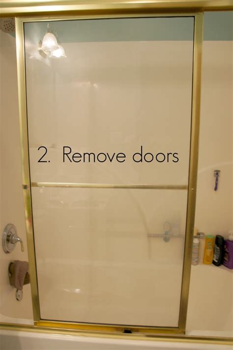 Carefully lift the door up until it's free from the tracks and then have your partner help you tilt it slightly to remove the door from the upper track. How to Remove Shower Glass Doors