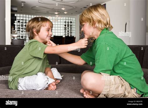 Two Boys Touching Each Others Chin And Smiling Stock Photo Alamy