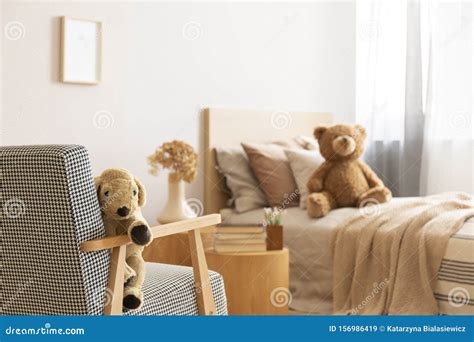 Teddy Bear On Single Wooden Bed In Natural Kid`s Bedroom Stock Image