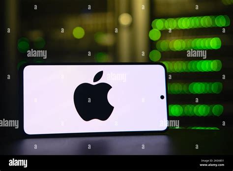 Apple Iphone Company Logo On The Background Of A Bokeh Server Light