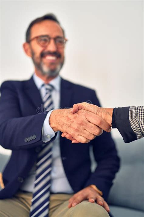 Two Middle Age Business Workers Smiling Happy And Confident Stock Photo