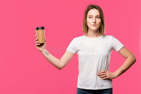Pretty Tattooed Girl Showing Disposable Cup Of Coffee Isolated Stock