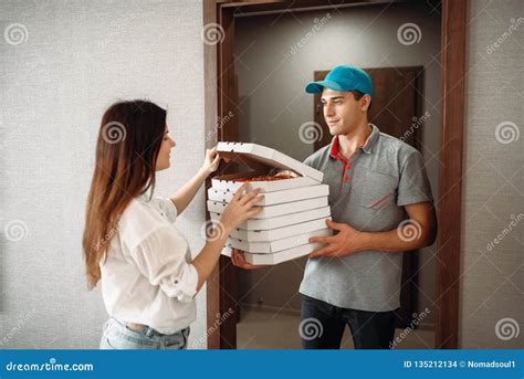 El Hombre De Entrega Muestra La Pizza Al Cliente En La Puerta Foto De
