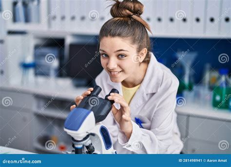 Adorable Girl Scientist Using Microscope Working At Laboratory Stock