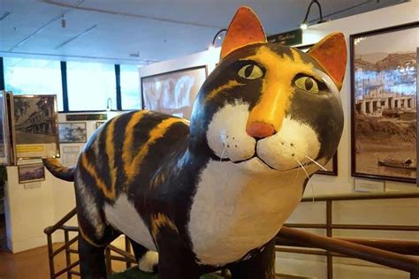 A Statue Of A Cat On Display In A Museum