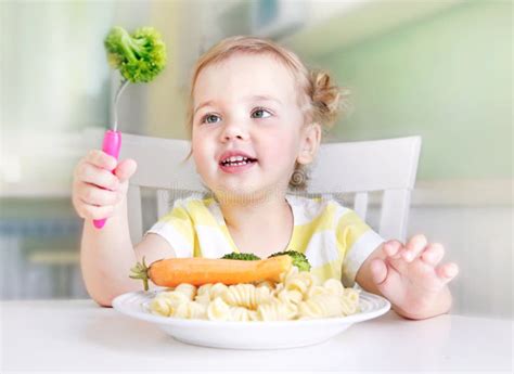 Little Child Girl Eating Healthy Food Home At Table Stock Image Image