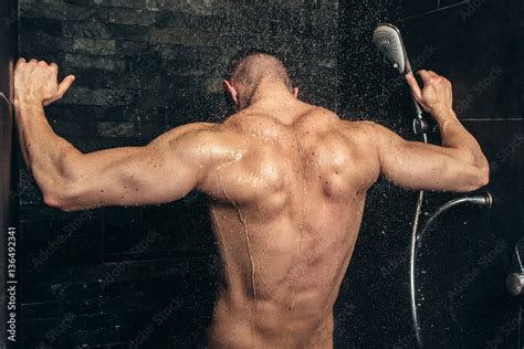 Muscular Fitness Bodybuilder Taking A Shower After Training Close Up Details Of Back Muscles In