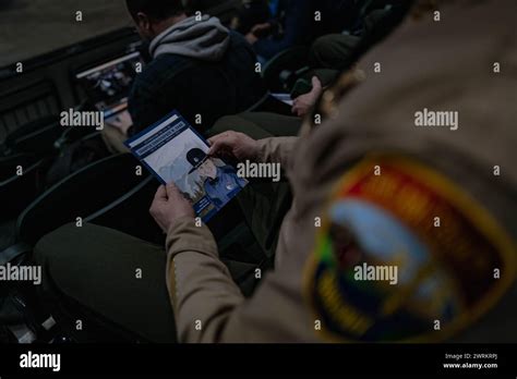 A trooper holds a poster of Washington State Patrol trooper Chris Gadd