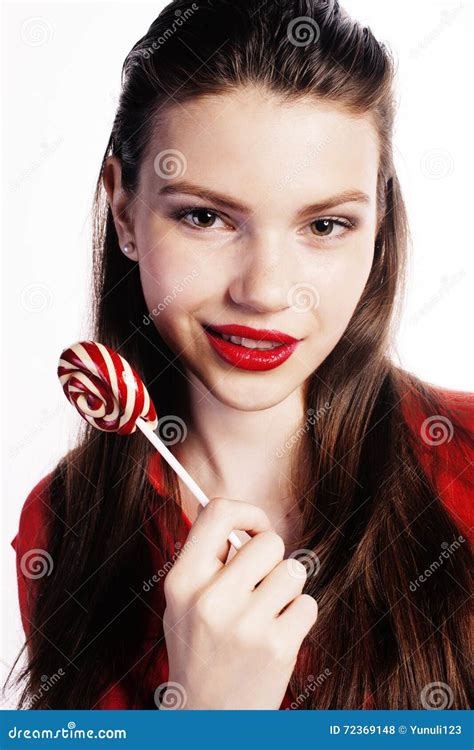 Young Pretty Brunette Girl With Red Candy Posing On White Background
