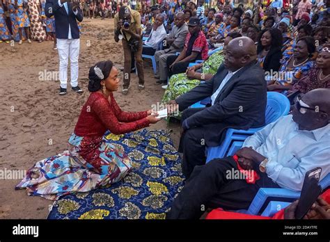 A Bride To Be Hands Her Father An Envelope Of Cash To Fulfill Her Dowry