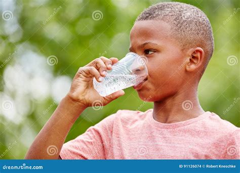 Thristy African Boy Drinks Water Stock Photo Image Of Fresh Cheerful