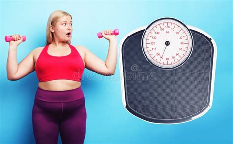 fat girl does gym but is worried because she does not decrease her weight cyan background stock