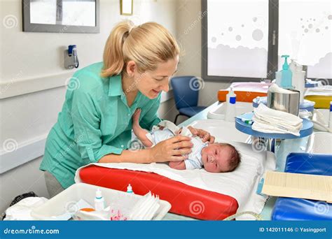 Mother Take Cares Of Her Newborn Baby In The Maternity Hospital First
