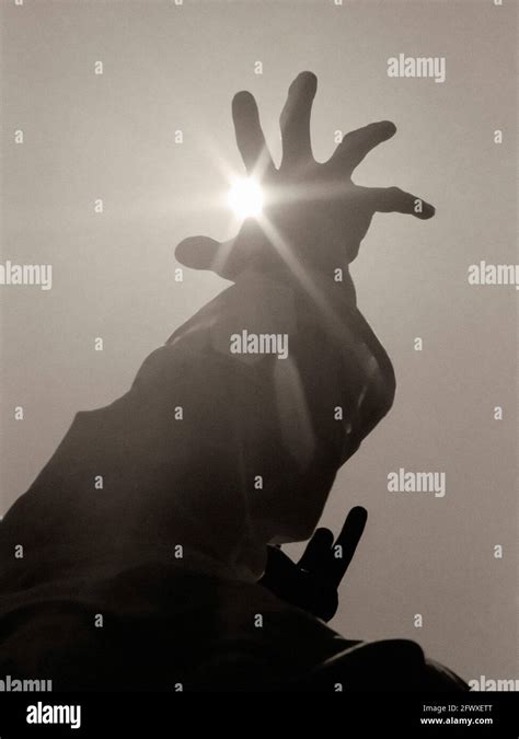 Mano Elevada A Sun Para Obtener Ayuda Fotografía De Stock Alamy