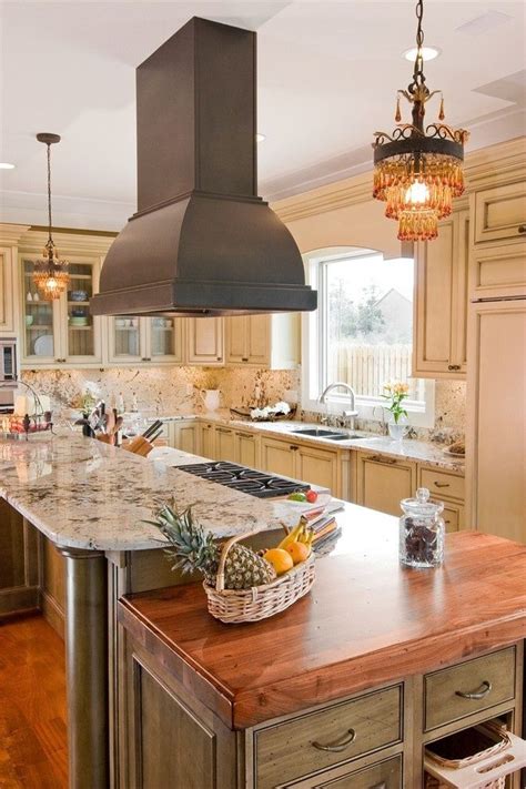 Take a look at these kitchen island ideas for inspiration for the cookspace of your dreams. free hanging vent hood, like the mini chandeliers too ...