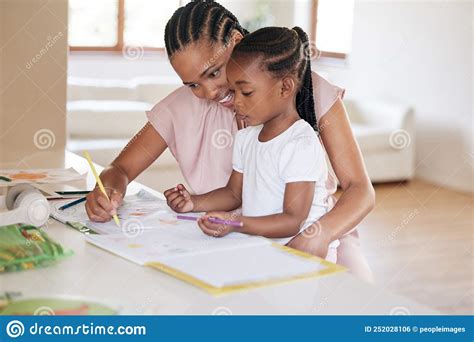 African American Girl Doing Homework With Her Mom A Beautiful Black Woman Helping Her Daughter