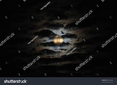 The Moon Shines In The Night Sky Among Clouds Stock Photo 34952650