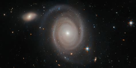 There are about 200 billion galaxies in the universe and known galaxies are about 100 billion. Image: Hubble views a not-so-lonely galaxy