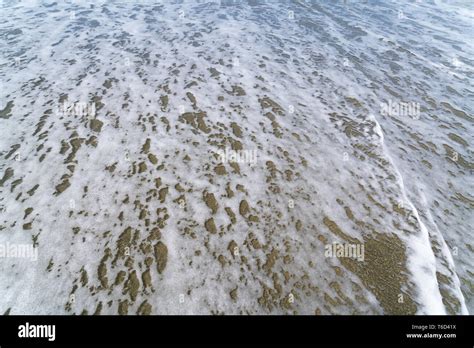 Foam Of A Wave On The Beach For Backgrounds Stock Photo Alamy